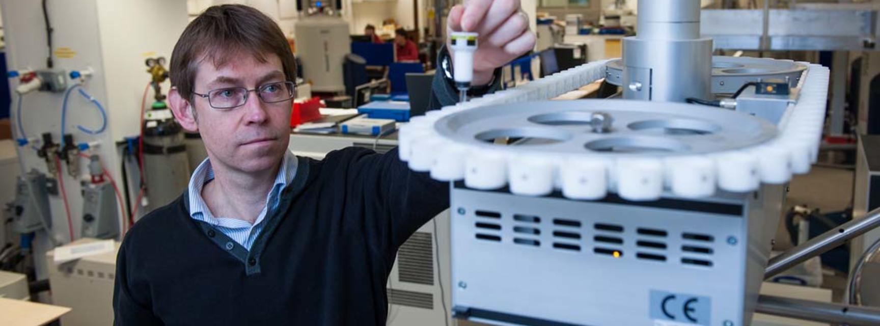 Photo of person in a laboratory undertaking NMR research