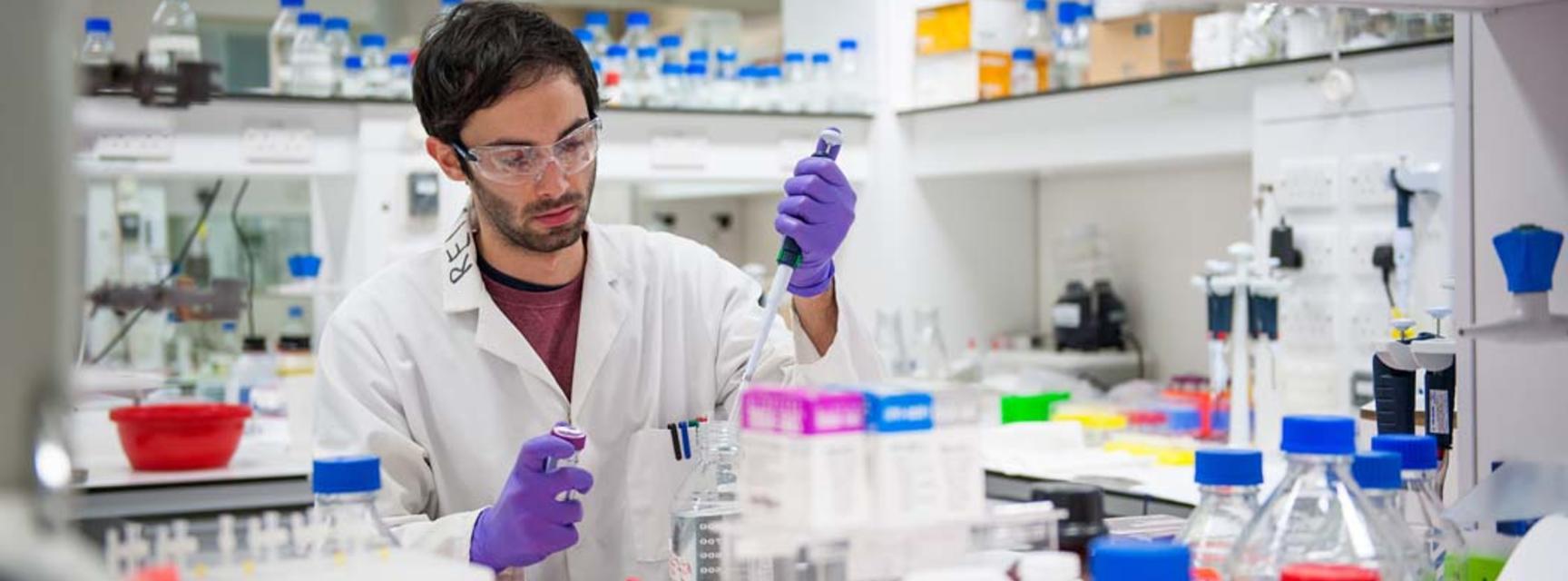 Photo of person in a laboratory undertaking research