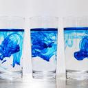 Three glasses with blue dye