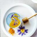Photo of a plate with flowers and Turmeric powder