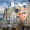 Photo of person in a laboratory undertaking research