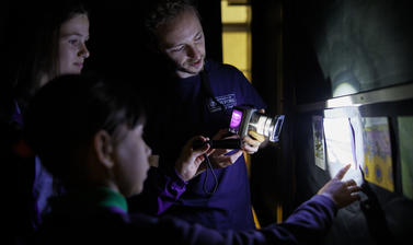 School students seeing visible-induced luminescence in action 