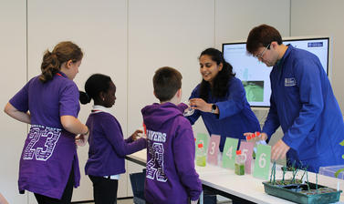 Image of students interacting with researchers