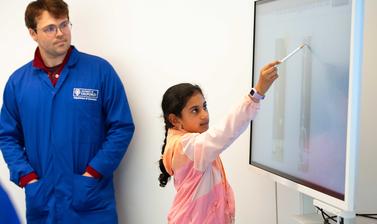 Image of student updating a whiteboard in a Building Bridges researcher session 