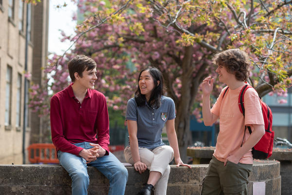 Students talking outside a laboratory.