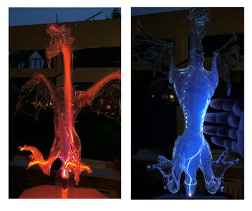 Two plasma illuminated glass sculptures of dragons, one red and one blue, designed and made by Terri Adams.