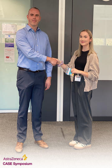 Claire Dooley receives a prize at the AstraZeneca CASE Symposium 2023.