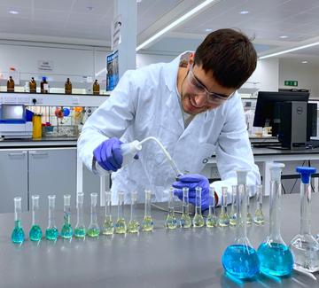 Image of student with volumetric flasks