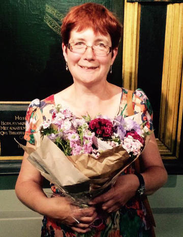 Sue henderson staff story photo of sue Henderson with a bunch of flowers